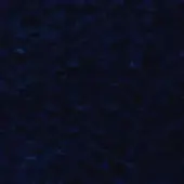 Dark blue mottled texture with granular pattern, displaying tonal shifts and an uneven surface resembling fabric, in shades of navy.